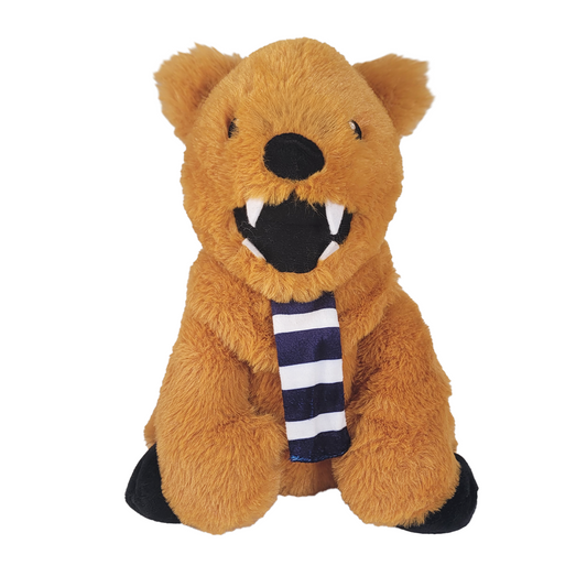 Plush toy lion with a striped scarf on a white background