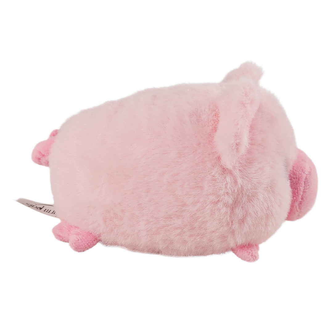 Side of pink pig plush toy on a white background