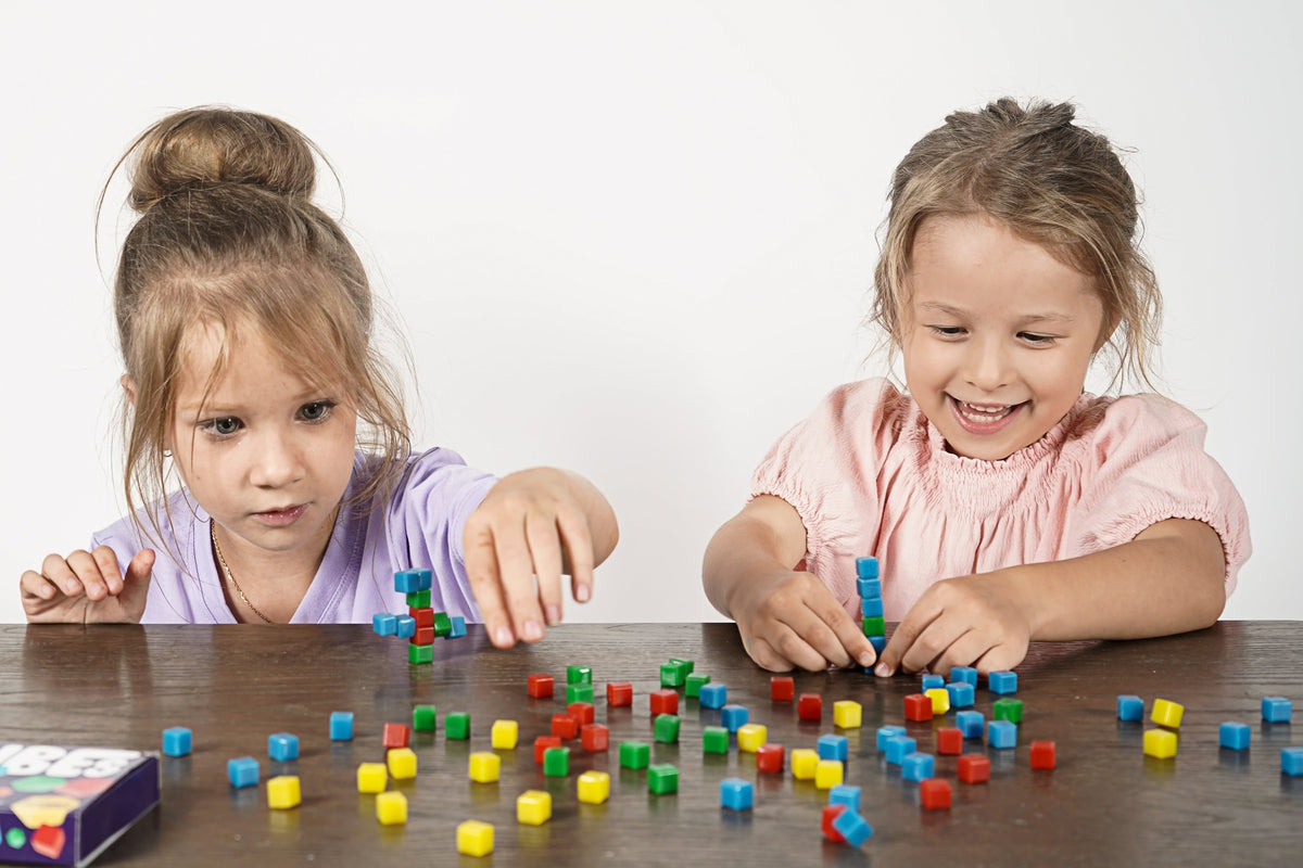 girls playing with stickikubes