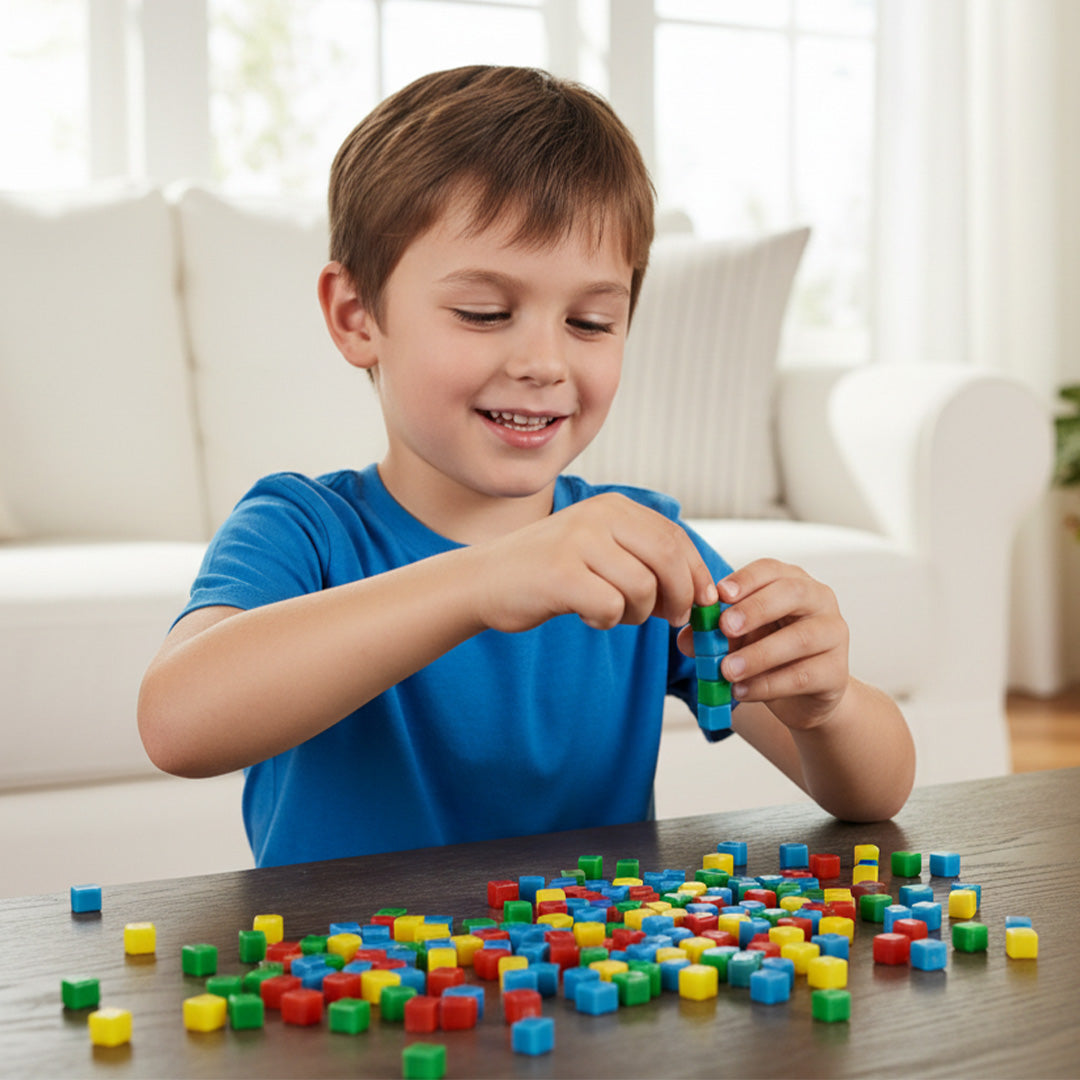 Child playing with colorful sticky building blocks on a table in a bright room.
