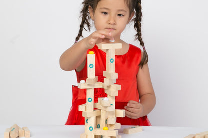 Child playing with the tumple game on a white background